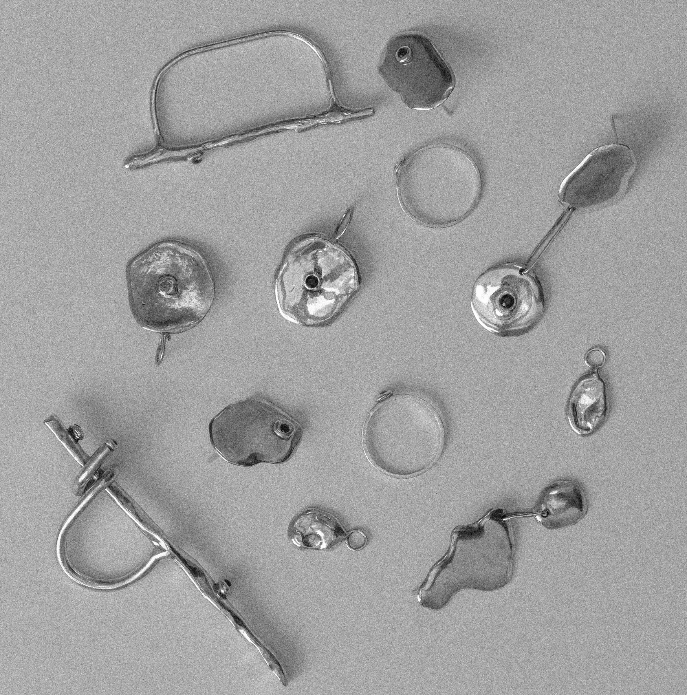 The Melt collection laid out: rings, earrings and pendants